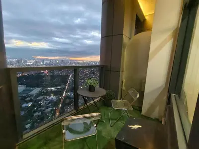 a balcony of a building with a table and chairs at 1 BR Loft type in Manila