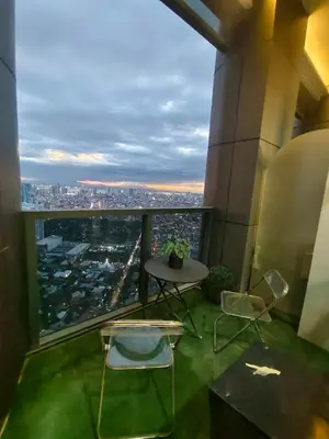 a room with a table and chairs in a building at 1 BR Loft type in Manila