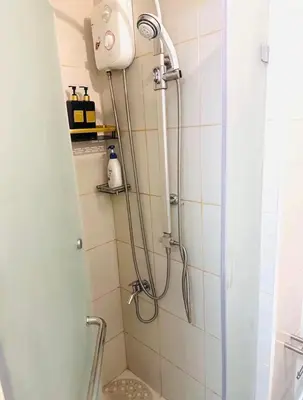 a shower with a shower head in a bathroom at Jazz Residences Condominium in Manila