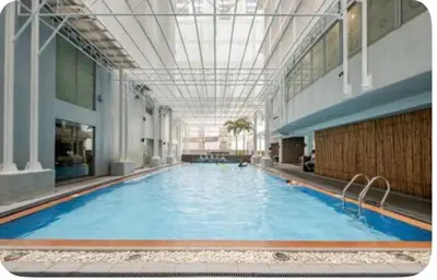 a large swimming pool in a large building at Studio in serenity - Peaceful and Calm ambiance in Manila