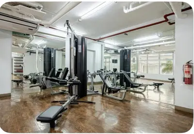 a gym with treadmills and machines in a room at Studio in serenity - Peaceful and Calm ambiance in Manila