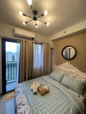 a bedroom with a bed with a stuffed animal on it at Shore 2 Residences, Tower 1 in Manila