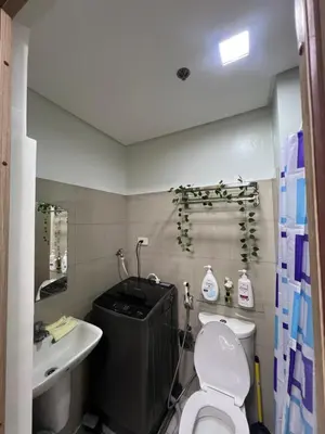 a bathroom with a white toilet and a sink at Shore 2 Residences, Tower 1 in Manila
