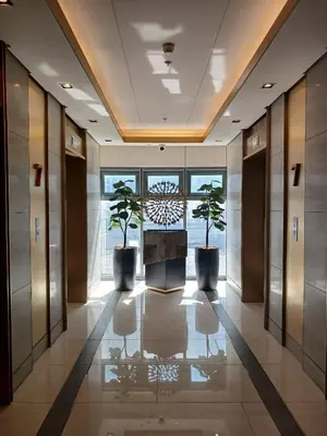 a hallway with two potted plants in a building at Blush & Glam at SMDC Fame Residences Tower 3 in Manila