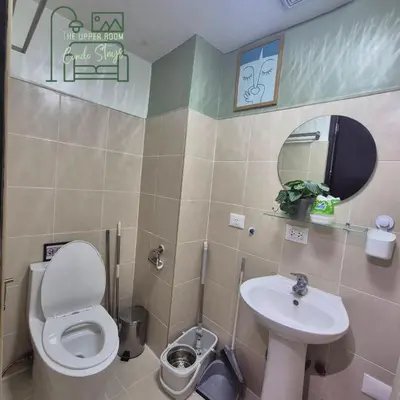 a small bathroom with a toilet and a sink at 1128 Positano in Manila
