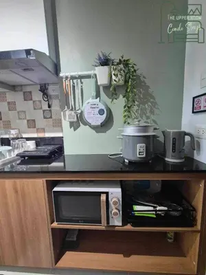 a kitchen with a counter top with a microwave at 1128 Positano in Manila