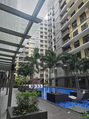 a swimming pool in the middle of a building at Gentry Manor Okada Westside City Paranaque by Royale Prestige Le Maison in Manila