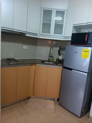 a kitchen with a refrigerator and a sink at Cluster 1 9N in Manila