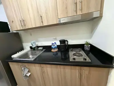 a small kitchen with a sink and a stove at Nordic Style 1br Shore 2 Residences Tower 3 in Manila