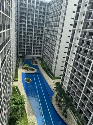 a pool in the middle of two tall buildings at Nordic Style 1br Shore 2 Residences Tower 3 in Manila