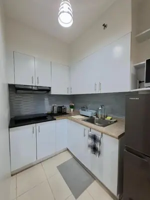a kitchen with white cabinets and a sink at Cozy Hotel-Style 1 Bedroom Condo Unit Bryant Tower 12E at Eastbay Residences by Rockwell in Manila