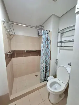 a bathroom with a toilet and a shower at Cozy Hotel-Style 1 Bedroom Condo Unit Bryant Tower 12E at Eastbay Residences by Rockwell in Manila