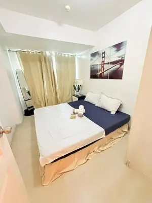 a bedroom with a large bed in a room at Azure Destiny's Suites 1912 in Manila