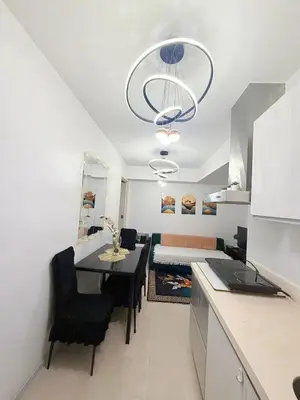 a kitchen and dining room with a table and a room with a bed at Azure Destiny's Suites 1912 in Manila