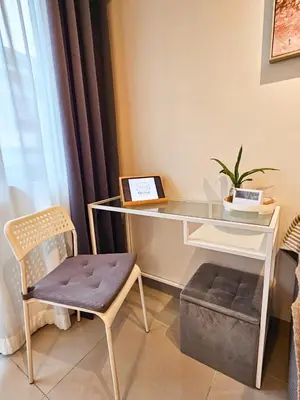 a desk with a chair next to a window at Haven Home in Manila