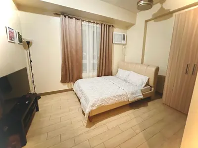 a small bedroom with a bed and a window at Cozy maple grove studio with hot shower in General Trias