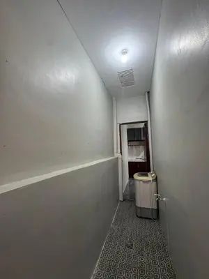 an empty hallway with a trash can in a room at Tan's Homestay in Trece Martires