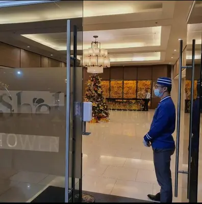 a man wearing a mask standing in a lobby at MOA Condo Stay with balcony Pool View 2 Beds in Manila