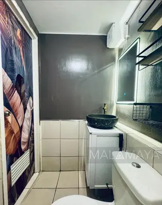 a bathroom with a sink and a toilet at Malamaya Staycation in Manila