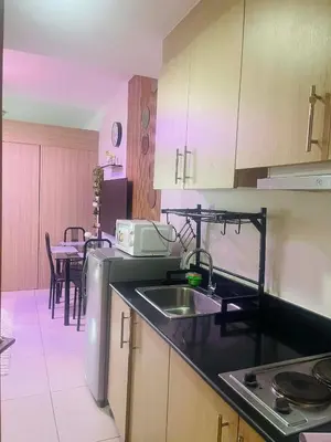 a kitchen with a sink and a counter top at Breeze Residences in Manila