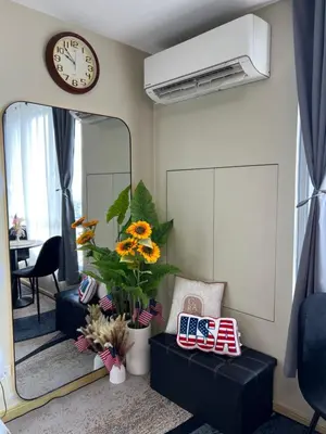 a living room with a mirror and a clock at Great View at Pioneer Mandaluyong Free Pool Gym Netflix Fast Wifi in Manila