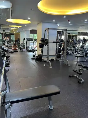 a gym with several tread machines in a room at Great View at Pioneer Mandaluyong Free Pool Gym Netflix Fast Wifi in Manila