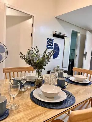 a table with plates and bowls on top of it at Staycation Casa Filipina in Manila