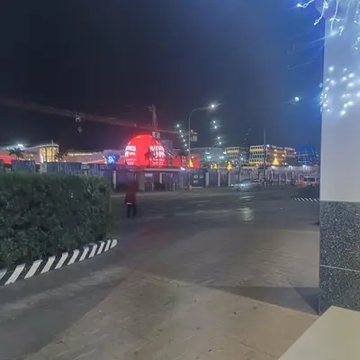 an empty parking lot at night with a building at Sea Residences StaycationAtMOA in Manila