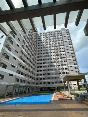 a large building with a swimming pool in front of it at SELF CHECK-IN Near La Salle Dasma in Dasmariñas