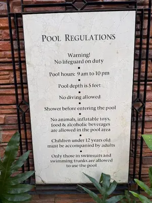 a sign that reads pool regulationswarning no lifeguard on duty at The Luxe Forbeswood BGC in Manila