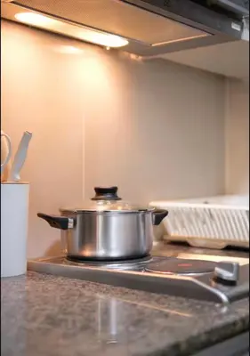 a pot sitting on top of a stove in a kitchen at BGC Uptown Condotel in Manila