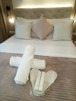 a bed with knee braces and a book on it at Royal Suites at Shore Residences near SM MOA and Airport in Manila