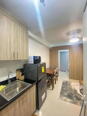 a kitchen with a sink and a counter top at Staycation Marcos Residence in Manila