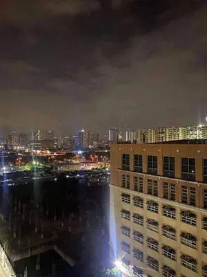 a view of a city at night with buildings at Staycation Marcos Residence in Manila