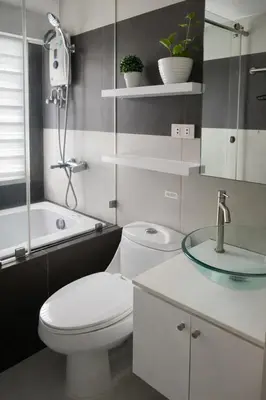a bathroom with a white toilet and a sink at Stylish Stay in BGC 5th Ave with Free Parking in Manila