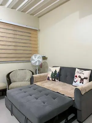a living room with a couch and a table at 1BR Cozy Townhouse - AC in room only in General Trias