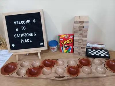a table with a display of chocolate vases and a chalkboard at 1BR Cozy Townhouse - AC in room only in General Trias