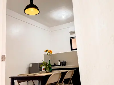 a kitchen and dining room with a table and chairs at LAD Private Reosrt in Dasmariñas