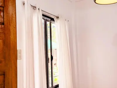 a window with white curtains in a room at LAD Private Reosrt in Dasmariñas