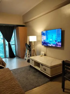 a bedroom with a large flat screen tv on the wall at Cluster4 4A in Manila