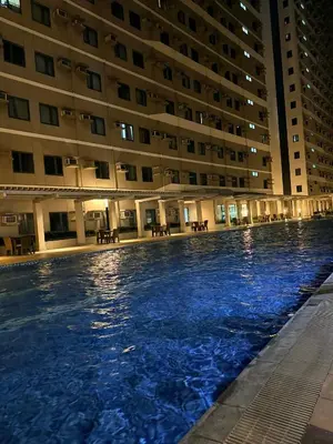 a large swimming pool in front of a building at Katya Suite in Pasong Bayog