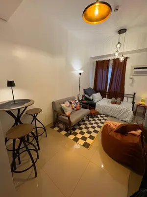 a living room with a couch and a table at Katya Suite in Pasong Bayog