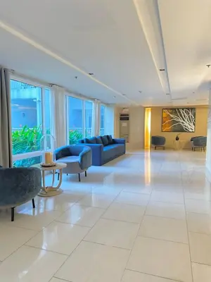 a large living room with a couch and chairs at Shell Residences MOA by Seph in Manila