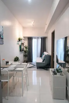 a living room with a table and a couch at Cozy Unit at Shore 3 Residences Tower 4 near MOA in Manila