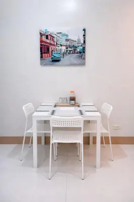 a white table and chairs in a room at Cozy Unit at Shore 3 Residences Tower 4 near MOA in Manila