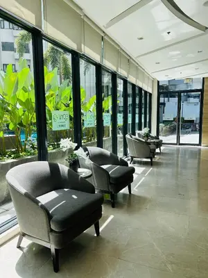 a lobby with couches and chairs in a building at Casa Bella Retreat in Manila
