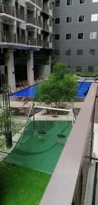 an empty playground in an apartment building with a swing at Vienna's Accomodation in Manila