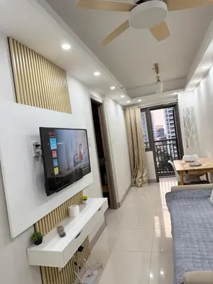 a living room with a flat screen tv on a wall at S residence tower 3 Friendship family hotel in Manila