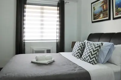 a bedroom with a bed with a white towel on it at Sarasota Residential Resort Manila in Manila