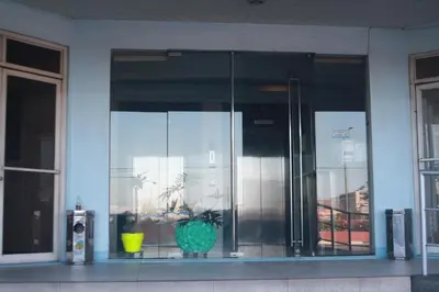 a glass building with a potted plant in a window at Touristation @ Crowne Bay Tower in Manila